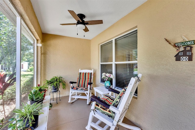 sunroom featuring ceiling fan