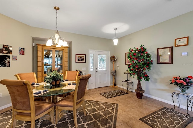 dining room with light tile floors and an inviting chandelier