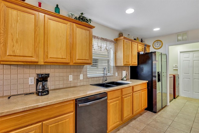 kitchen with backsplash, light tile floors, black appliances, and sink