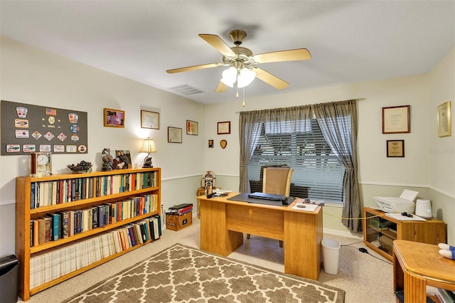 carpeted office space with ceiling fan