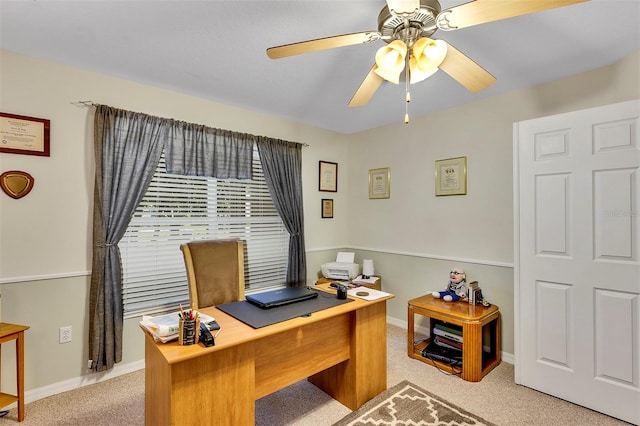 carpeted office featuring ceiling fan