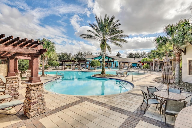 view of swimming pool featuring a patio and a pergola