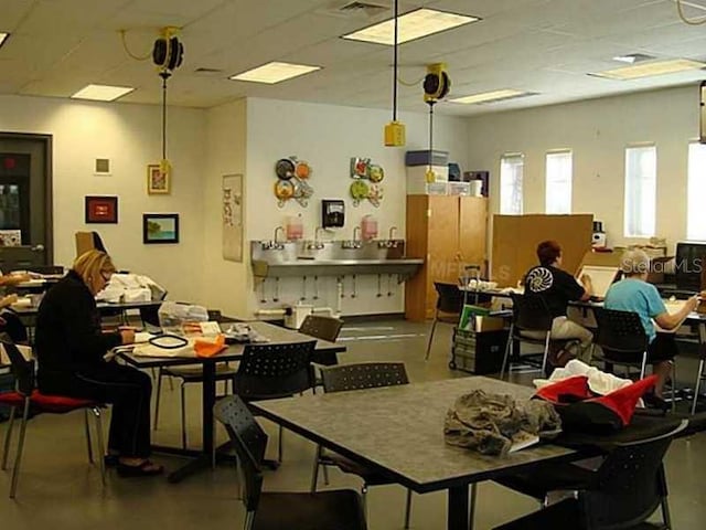 dining room featuring a drop ceiling