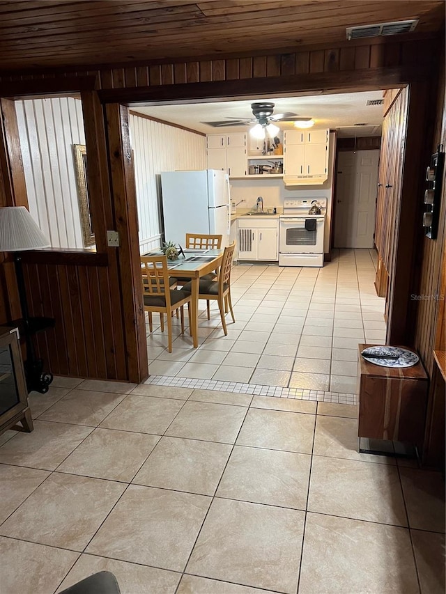 dining space with sink, ceiling fan, light tile floors, and wooden ceiling