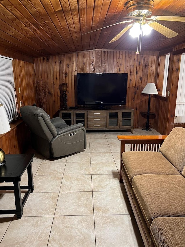 tiled living room featuring wood walls, ceiling fan, and wooden ceiling