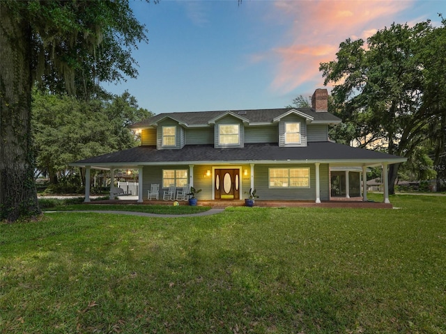 view of front of house featuring a lawn and covered porch