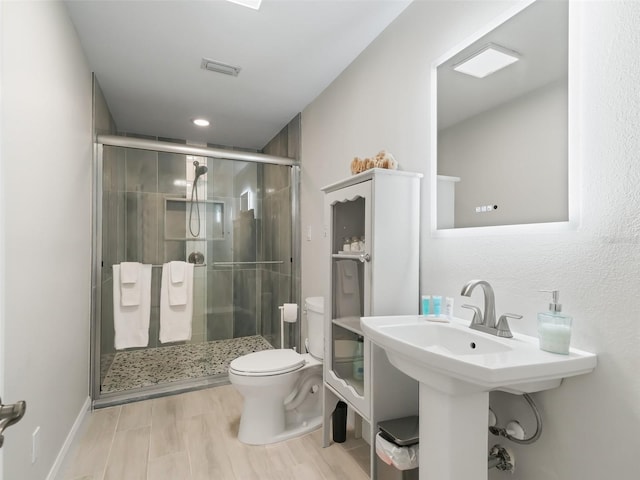 bathroom featuring walk in shower and toilet