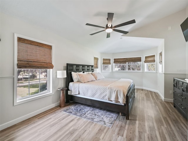 bedroom with wood-type flooring, ceiling fan, and vaulted ceiling