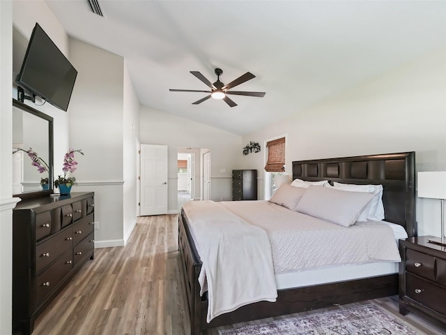 bedroom with vaulted ceiling, hardwood / wood-style floors, and ceiling fan