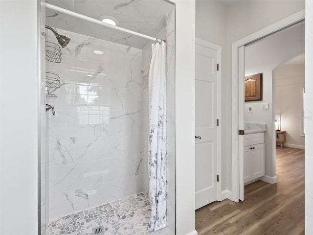 bathroom with a shower with curtain, vanity, and hardwood / wood-style flooring