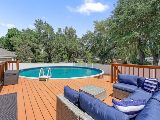 view of swimming pool featuring an outdoor living space and a wooden deck