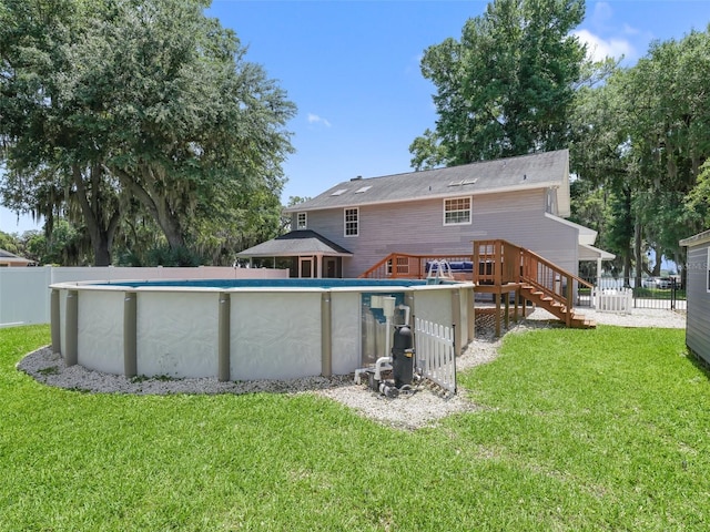 back of house with a yard and a pool side deck