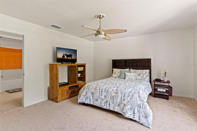 bedroom featuring a textured ceiling, ceiling fan, and carpet