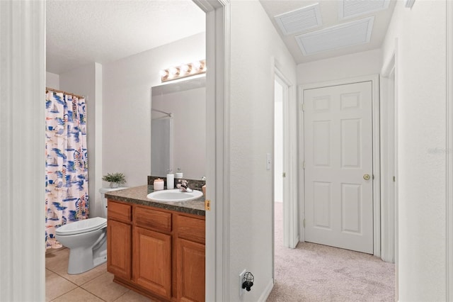 bathroom featuring a textured ceiling, vanity, tile floors, and toilet