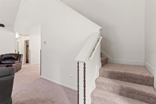 stairs with carpet floors and vaulted ceiling