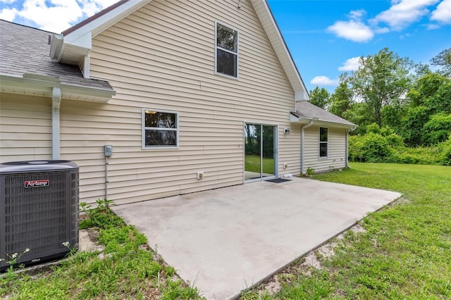 back of house with a patio area, central AC, and a lawn