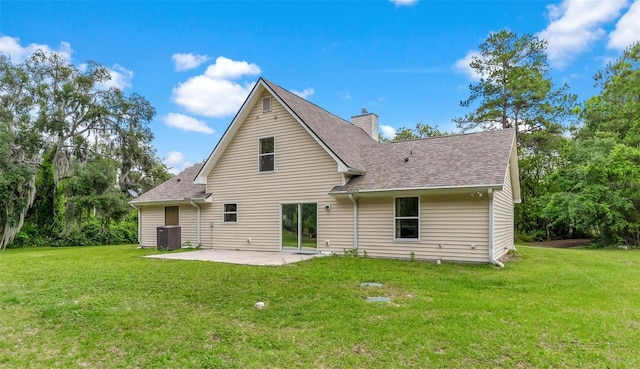 back of property with a yard, central air condition unit, and a patio area