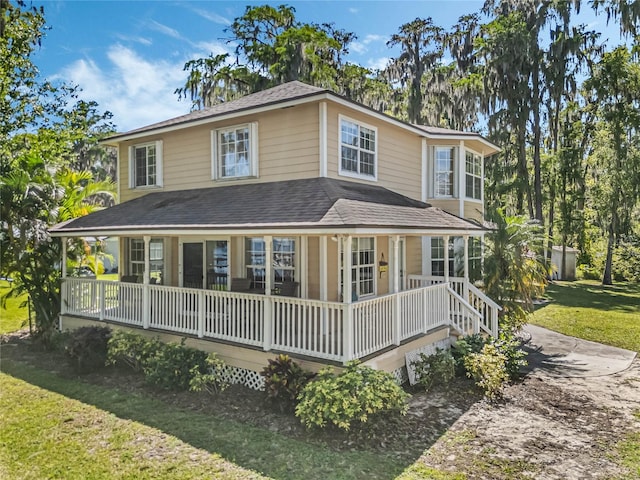 back of house featuring a porch and a lawn