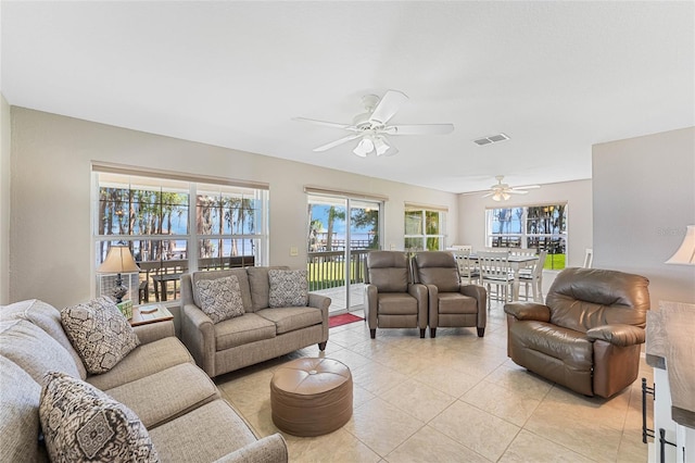 living room featuring ceiling fan and light tile floors