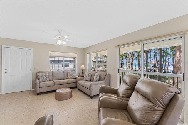 tiled living room featuring ceiling fan and plenty of natural light