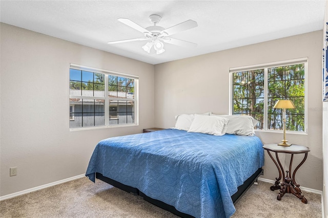 bedroom featuring light colored carpet and ceiling fan