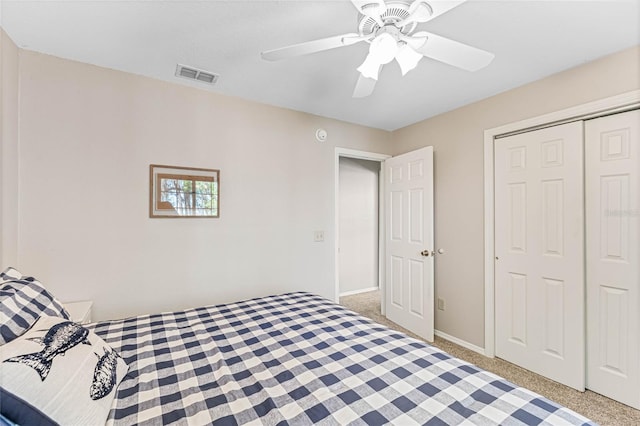 carpeted bedroom with a closet and ceiling fan