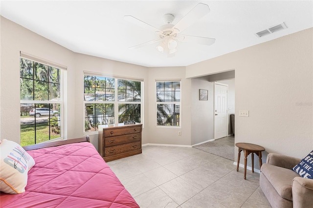 tiled bedroom featuring ceiling fan