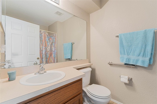 bathroom featuring toilet and vanity