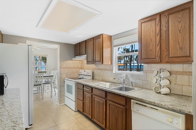 kitchen featuring white appliances, ceiling fan, tasteful backsplash, sink, and light tile floors