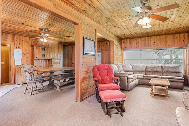 carpeted living room featuring wooden ceiling, wood walls, and ceiling fan