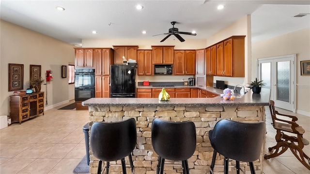23321 N Buckhill Rd, Howey In The Hills, FL 34737 - kitchen with black appliances, a peninsula, light tile patterned floors, recessed lighting, and a ceiling fan