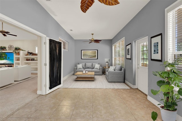 23321 N Buckhill Rd, Howey In The Hills, FL 34737 - living room with ceiling fan, light tile patterned floors, healthy amount of natural light, lofted ceiling, and light carpet
