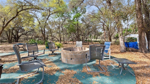 23321 N Buckhill Rd, Howey In The Hills, FL 34737 - view of patio / terrace featuring a fire pit and view of scattered trees