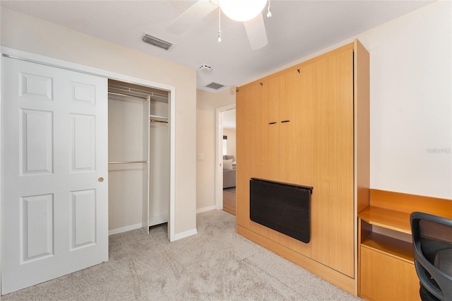 bedroom with light colored carpet, a closet, and ceiling fan