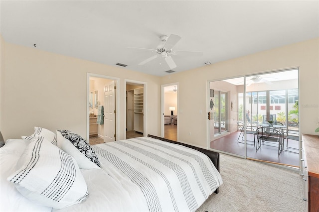 bedroom with light hardwood / wood-style floors, a walk in closet, access to exterior, a closet, and ceiling fan