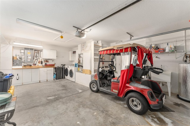 garage with washer and dryer, a workshop area, and a garage door opener