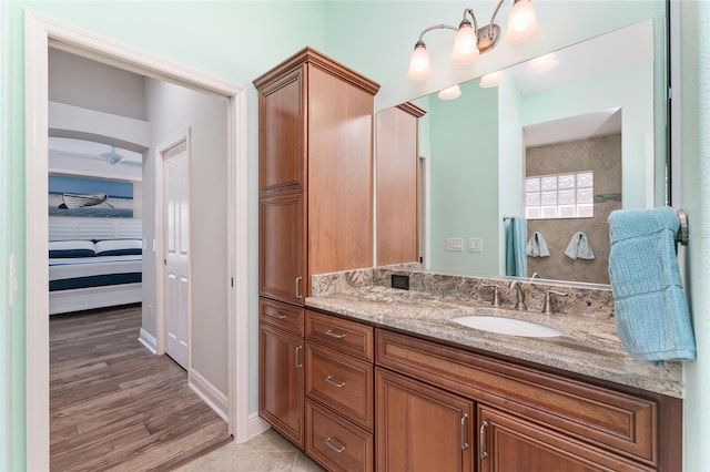 bathroom with ceiling fan, hardwood / wood-style floors, and vanity