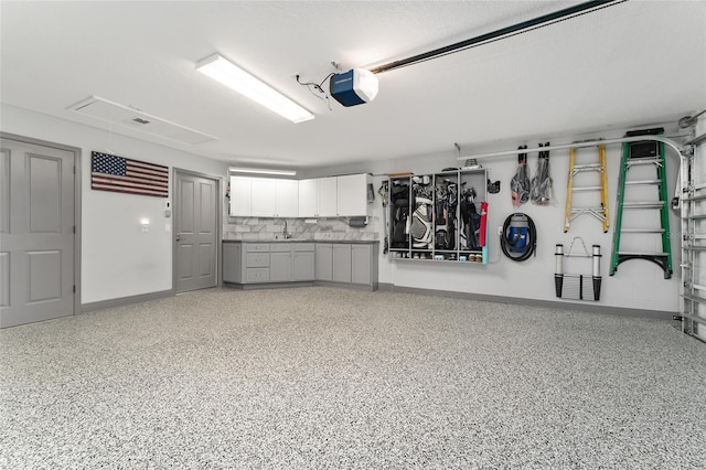 garage featuring sink and a garage door opener