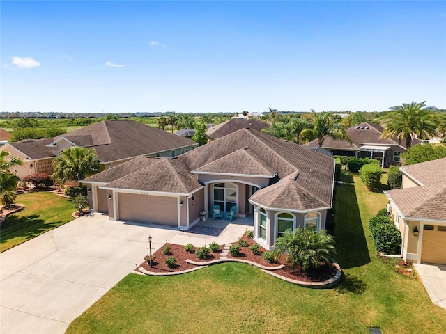 view of front of property featuring a garage and a front yard