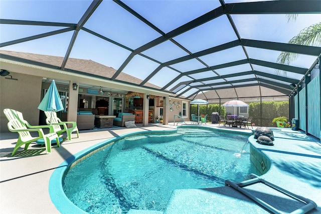 view of swimming pool featuring a patio area, glass enclosure, and area for grilling