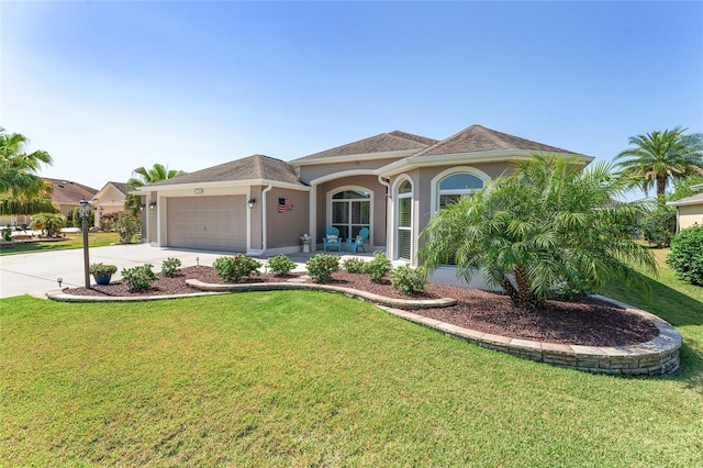 view of front of property with a garage and a front lawn