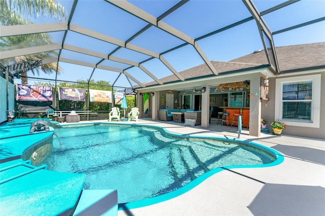 view of swimming pool featuring a patio area, a lanai, outdoor lounge area, and exterior bar