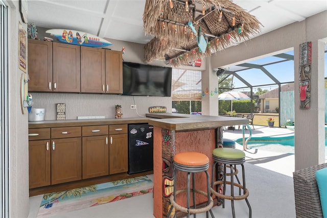 kitchen featuring a breakfast bar and refrigerator