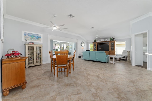 dining space with ceiling fan, light tile patterned floors, vaulted ceiling, and ornamental molding