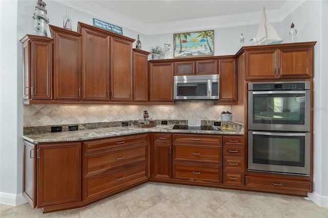 kitchen featuring appliances with stainless steel finishes, crown molding, decorative backsplash, and light stone counters