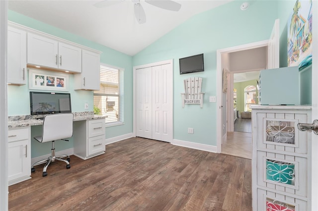 office area featuring lofted ceiling, ceiling fan, dark wood-type flooring, and built in desk