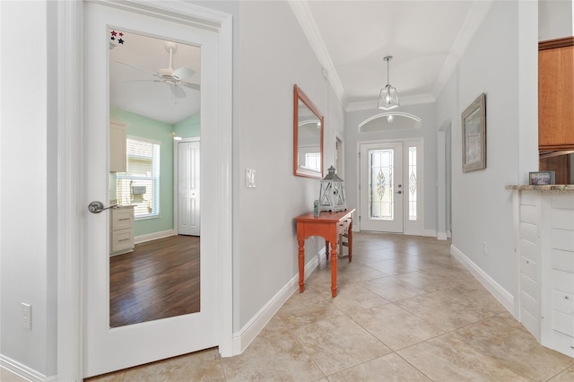 foyer featuring vaulted ceiling, ceiling fan, light tile patterned floors, and crown molding