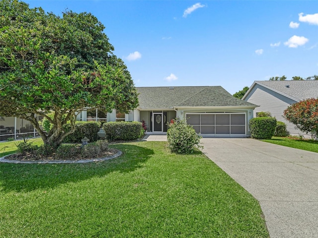 view of front of property with a garage and a front yard