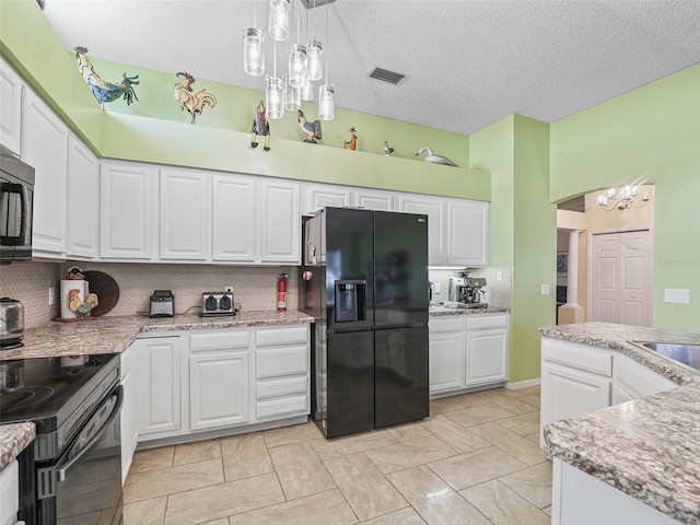 kitchen with black fridge with ice dispenser, tasteful backsplash, decorative light fixtures, and white cabinets