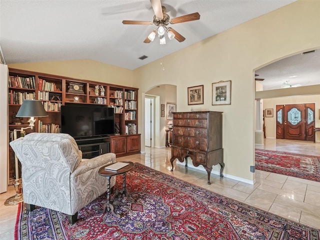 sitting room featuring lofted ceiling, ceiling fan, and light tile floors